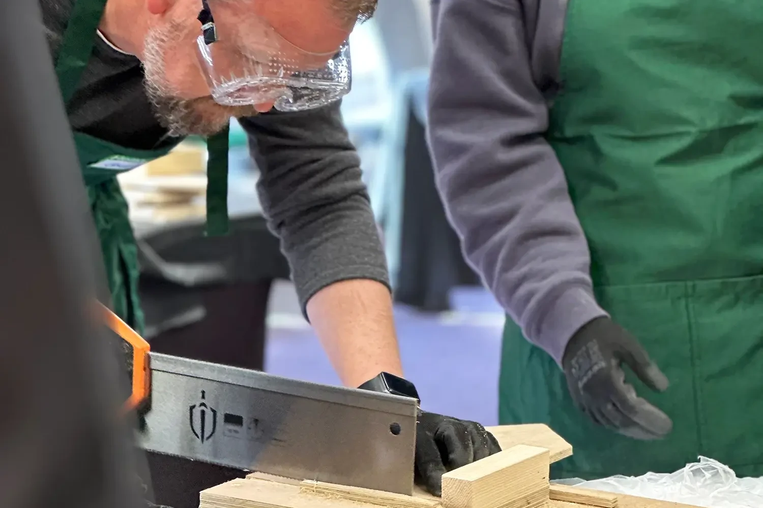 Bee hotel man cutting wood