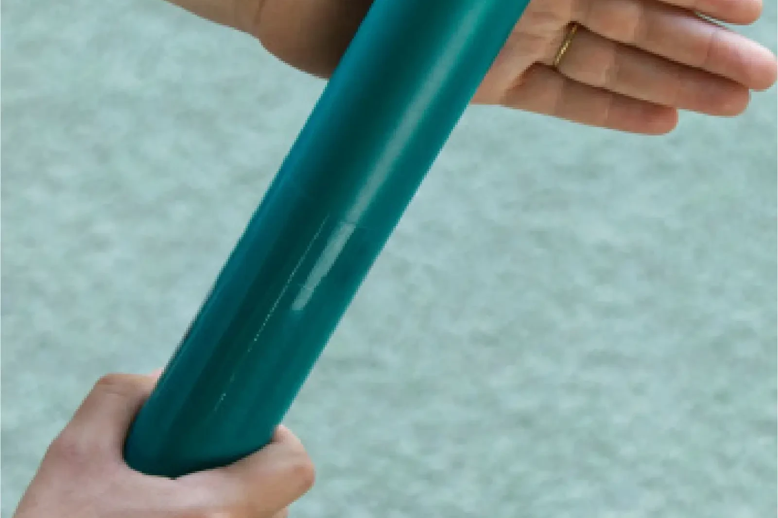 Hands holding colourful Boomwhacker