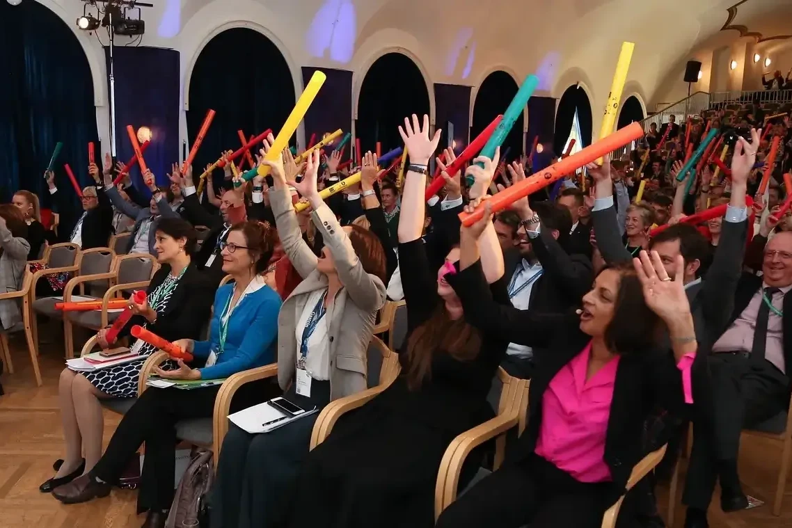 Audience playing Boomwhackers during corporate ice breaker