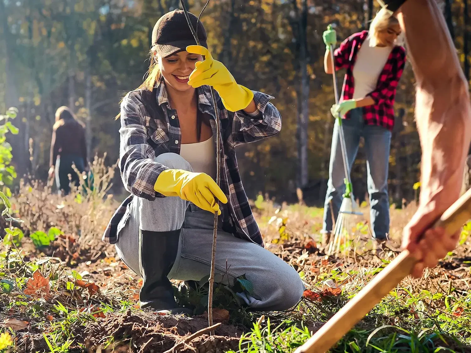 Women planting tree in CSR team building event