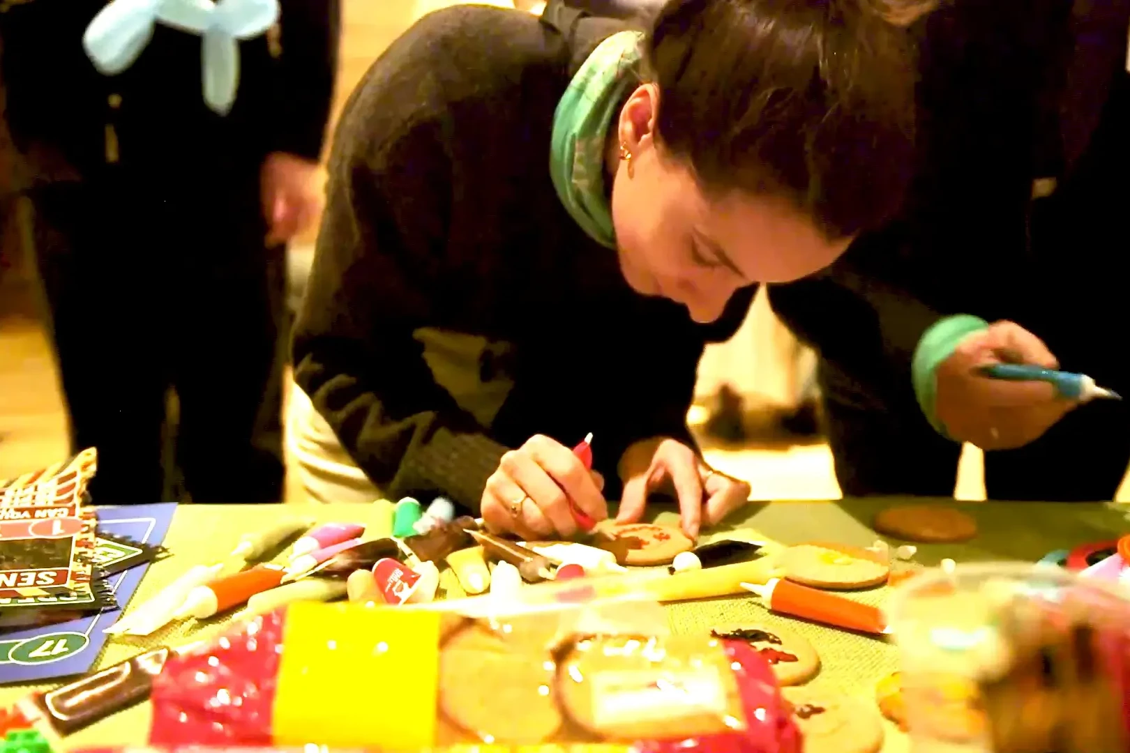 Women decorating cookie in corporate team building