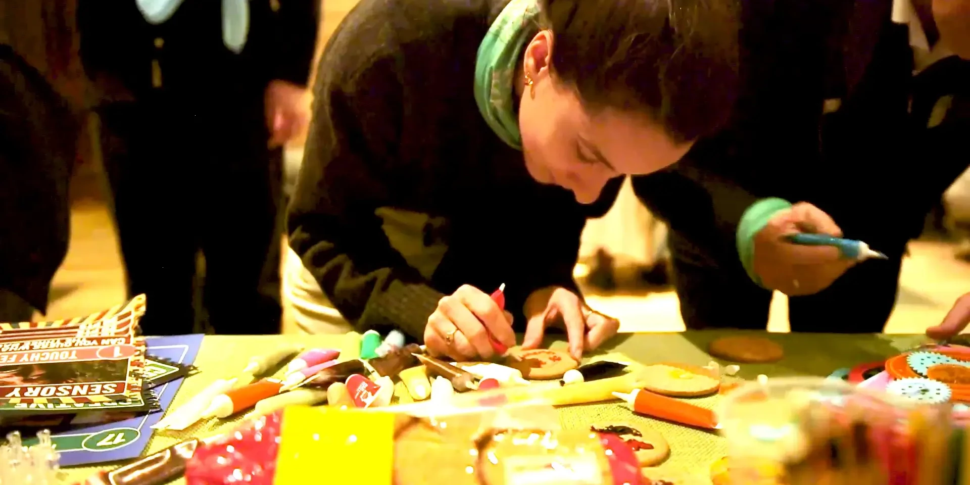 Women decorating cookie in corporate team building