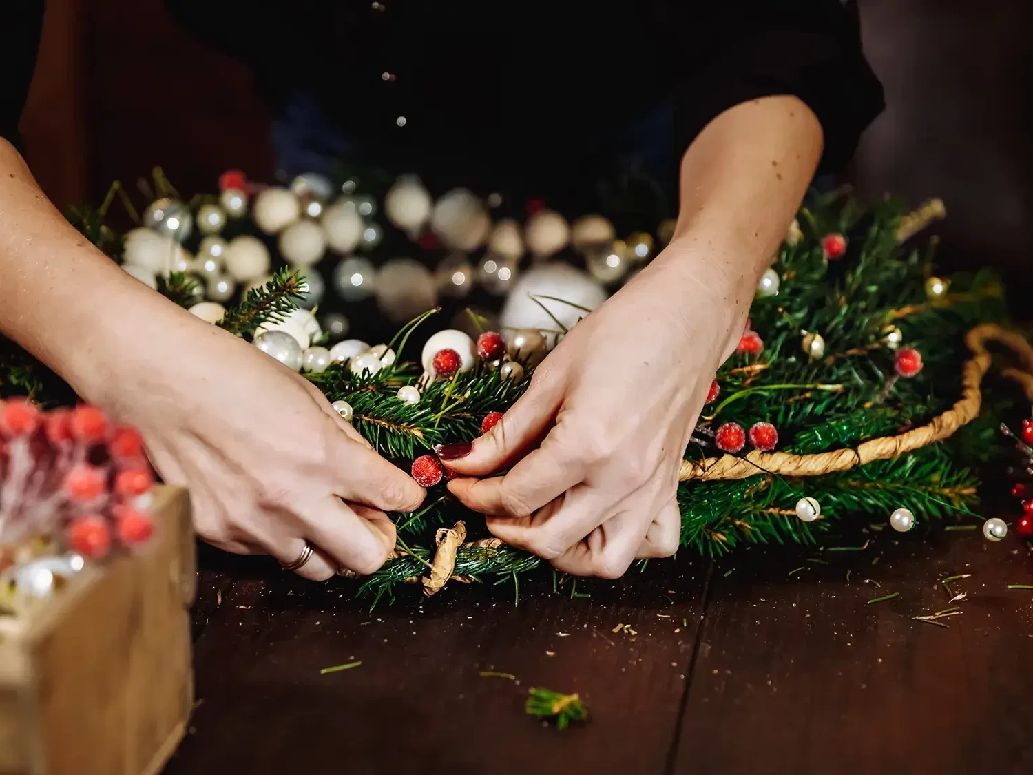 Team building participant decorating wreath in wreath making workshop