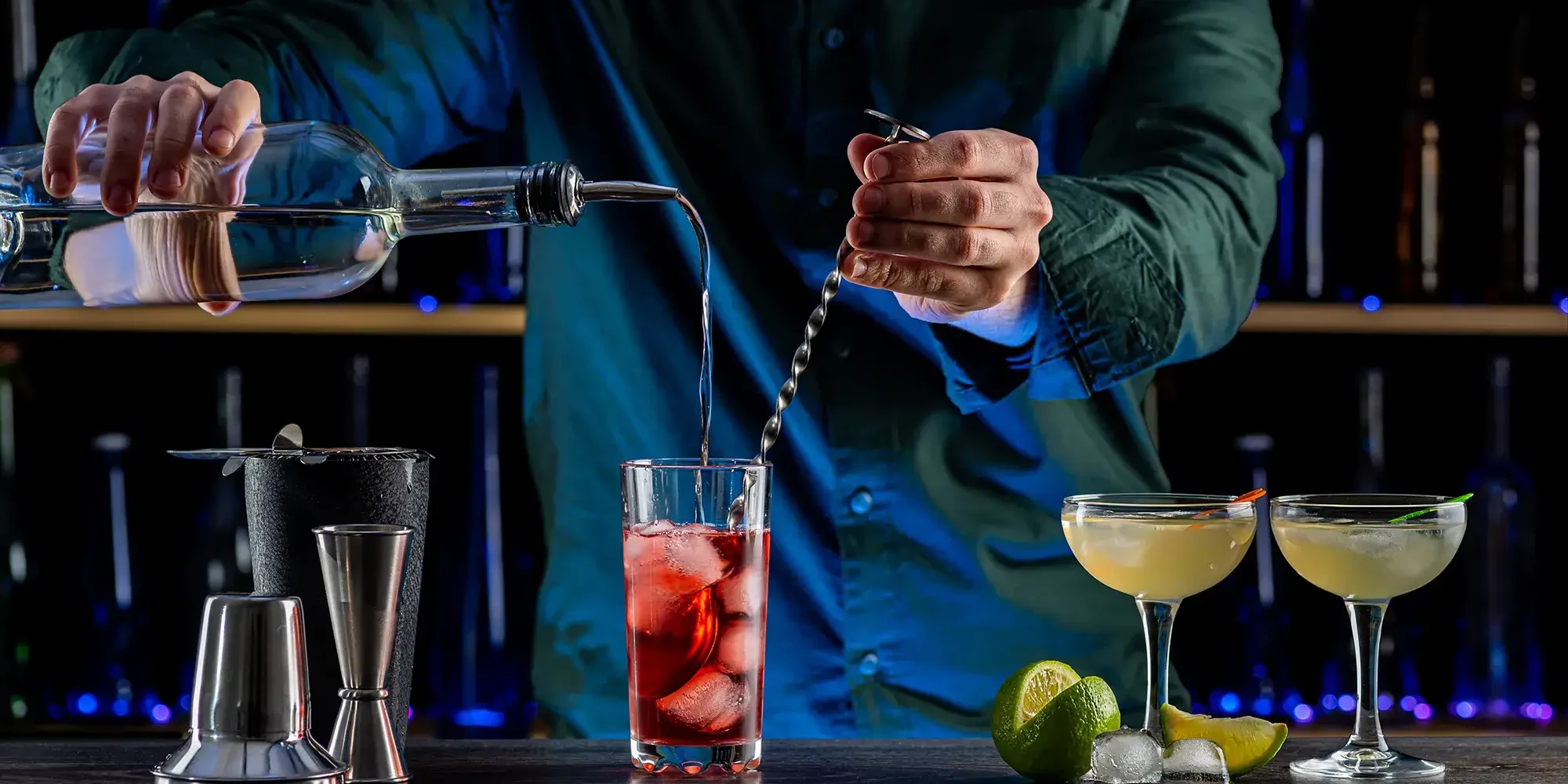 Mixologist mixing cocktail during cocktail making team building event