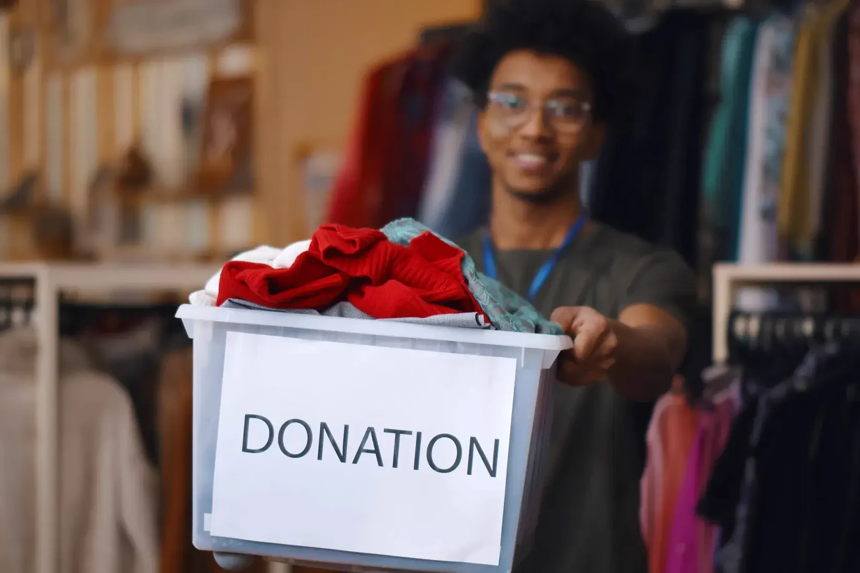 man donating clothes to charity after team building event