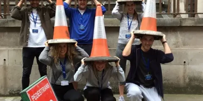 team posing with traffic cones for treasure hunt challenge
