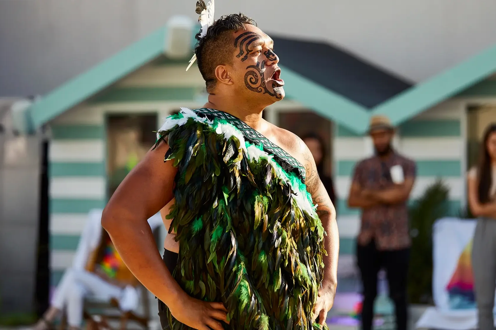 Maori with face paint and traditional costume performing the Haka in GOTO Events team building event outdoors