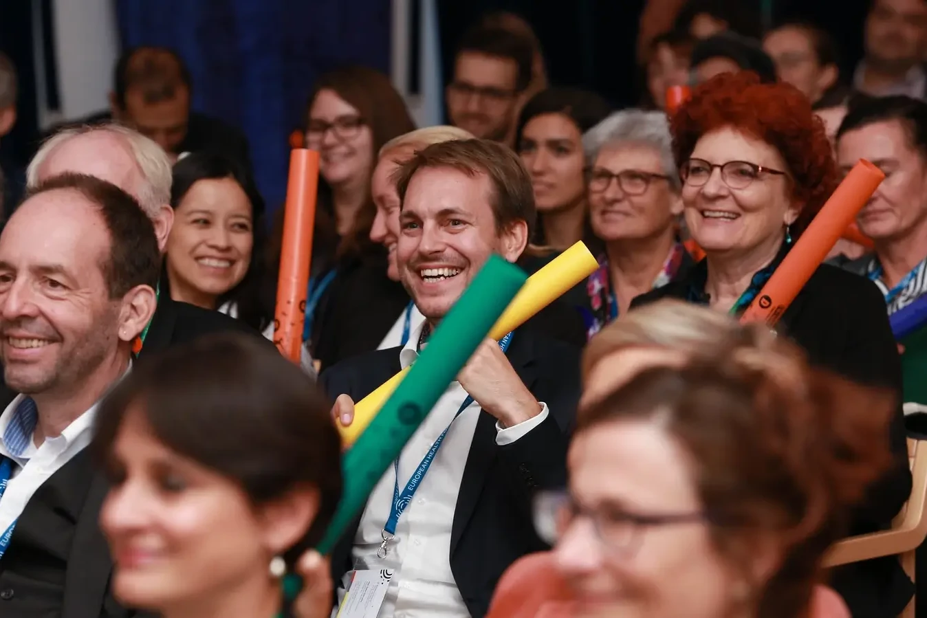 Happy audience playing Boomwhackers