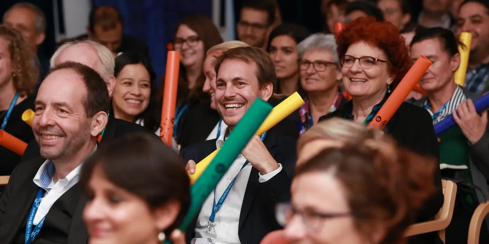 Happy audience playing Boomwhackers