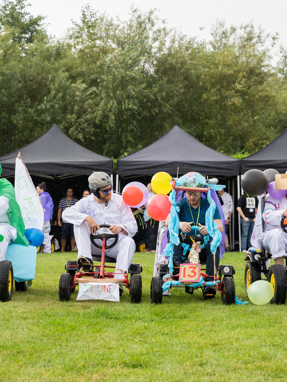 Employees competing in Soap Box Derby race in corporate summer event