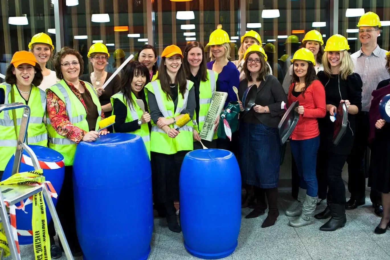 Group of team building participants in holding various objects for Junk Funk activity