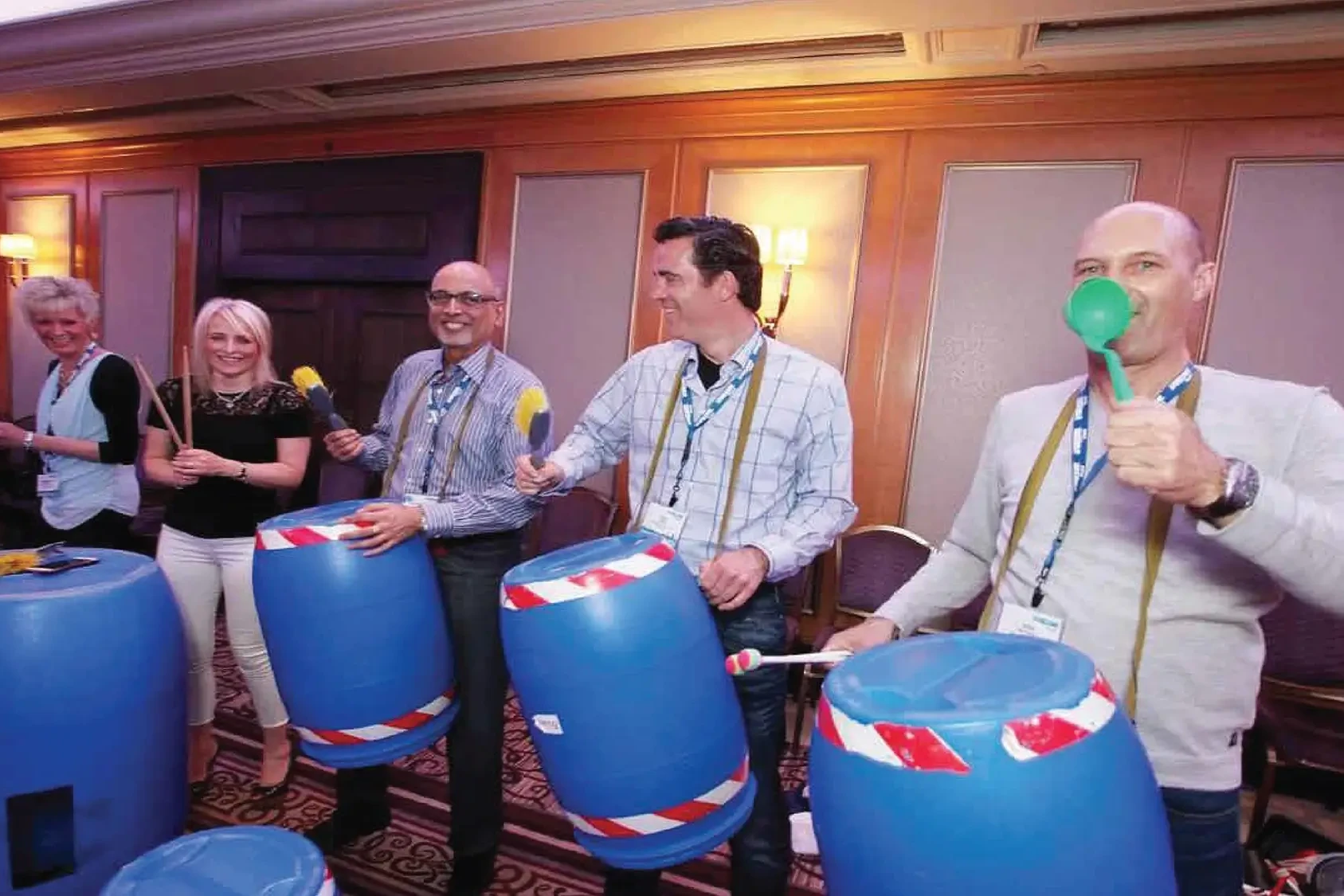 Junk Funk team building event with team drumming on blue barrels