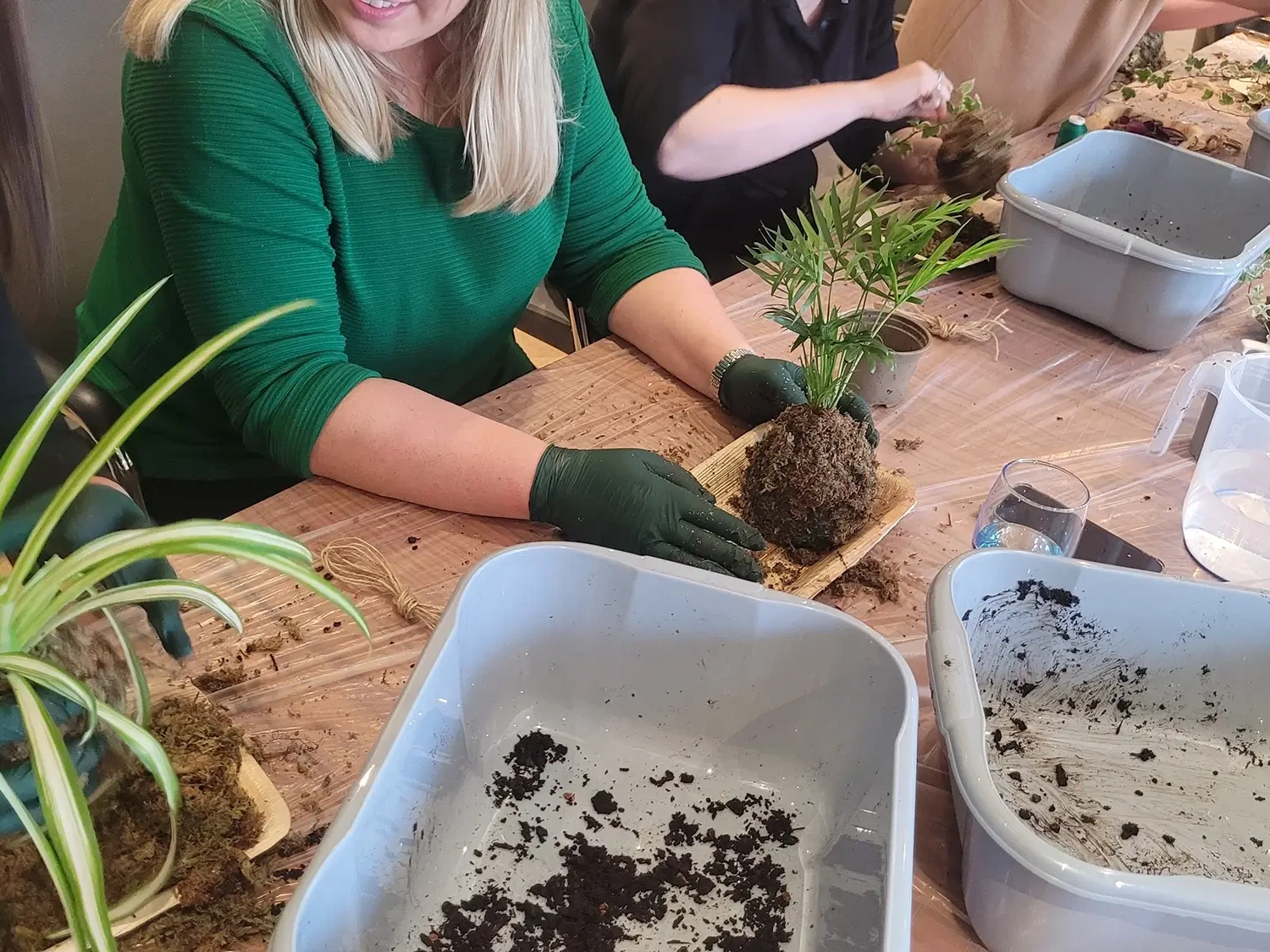 Kokedama team building participant and plant