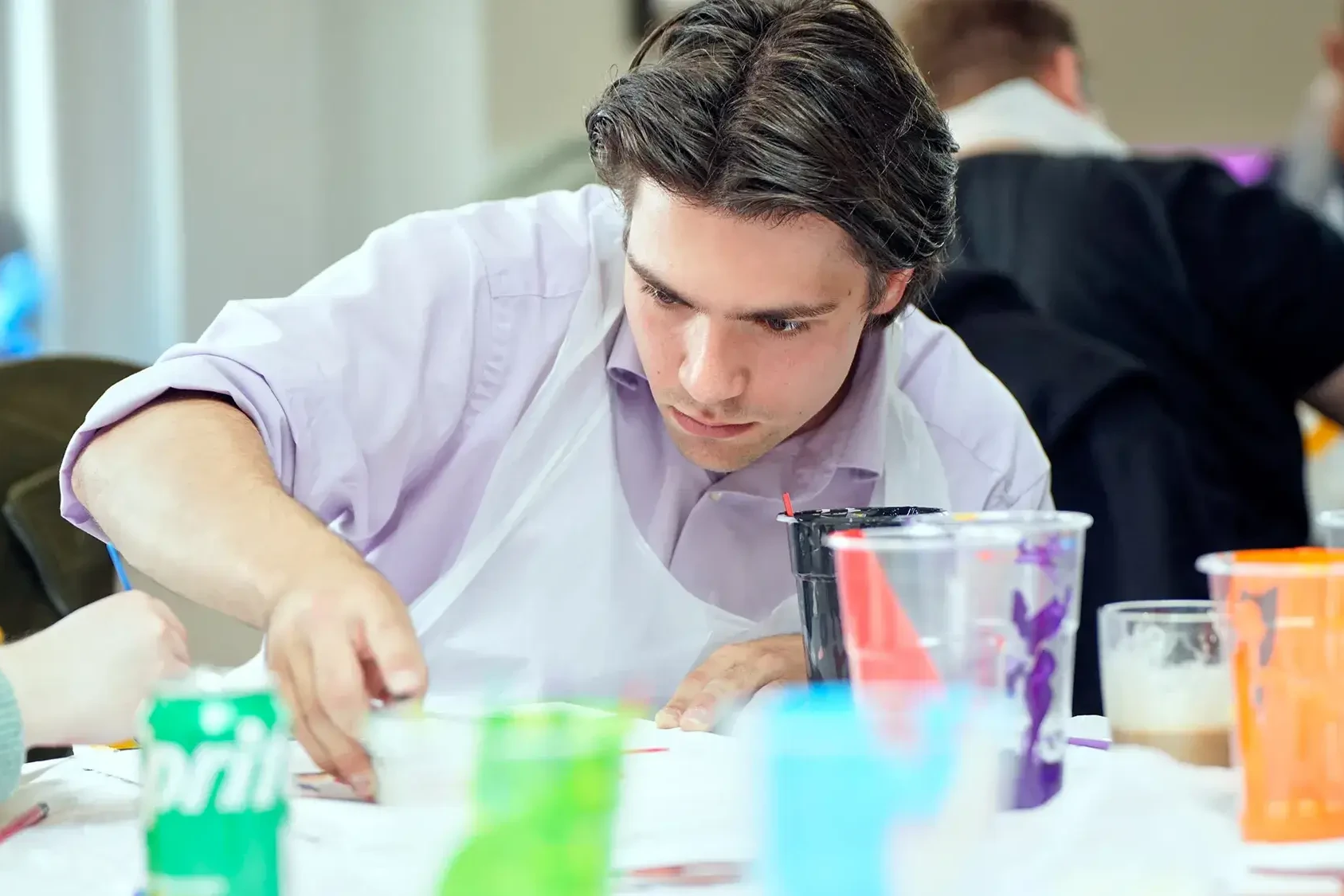 Indoor team building participant concentrating on Masterpiece activity