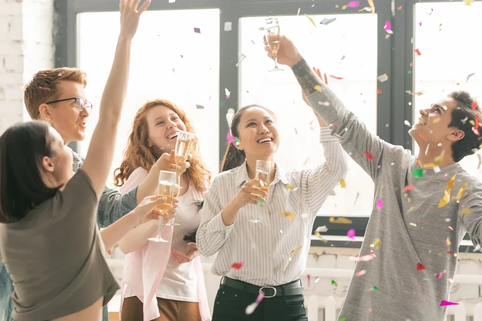 Team celebrating with confetti and drinks