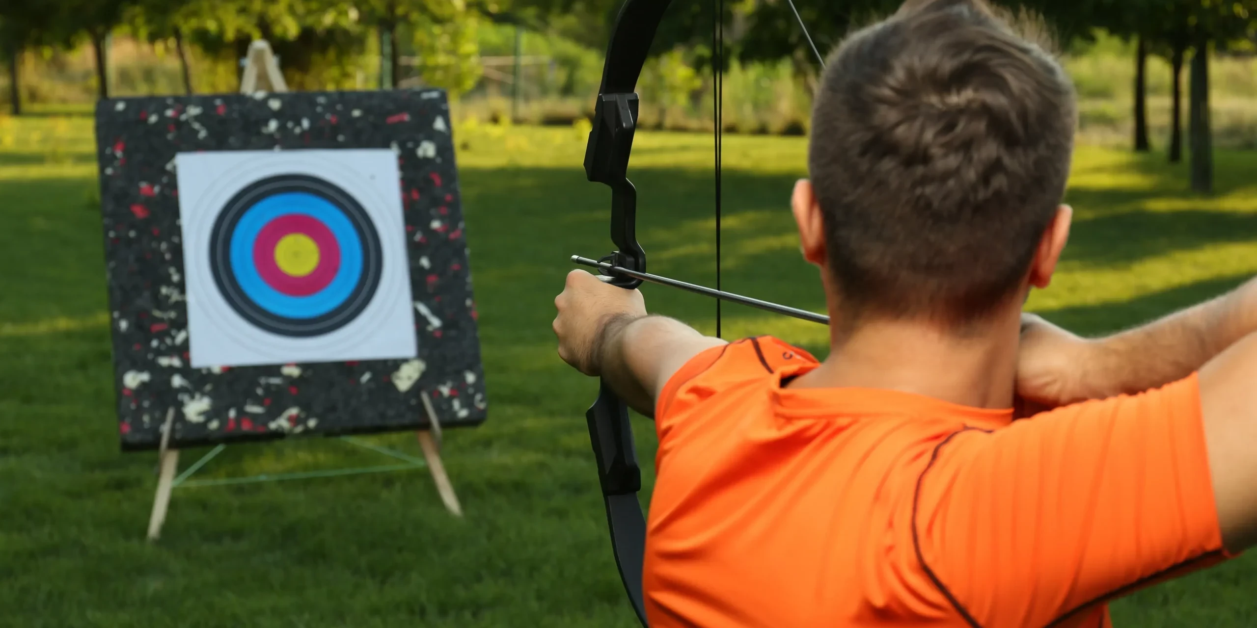 Person aiming at target in archery team building activity