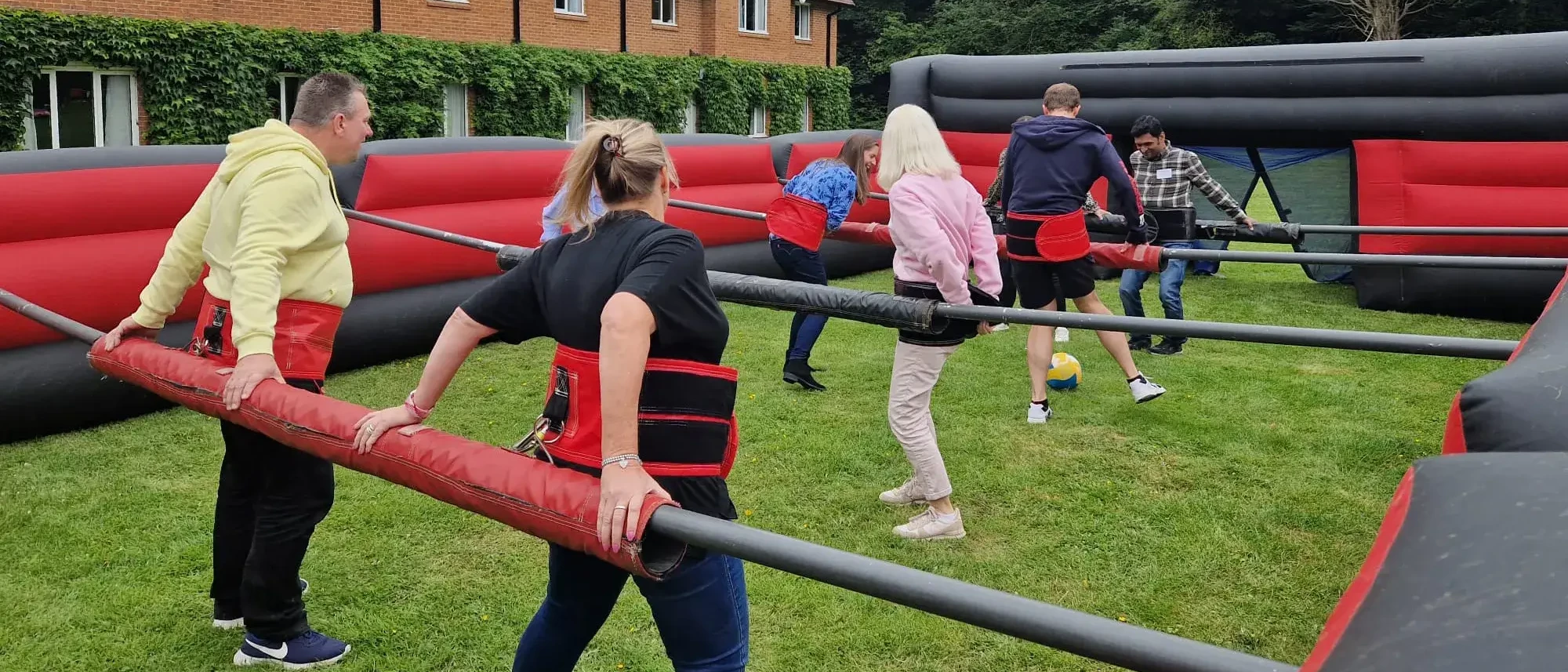 people playing football in Olympic sports day human table football