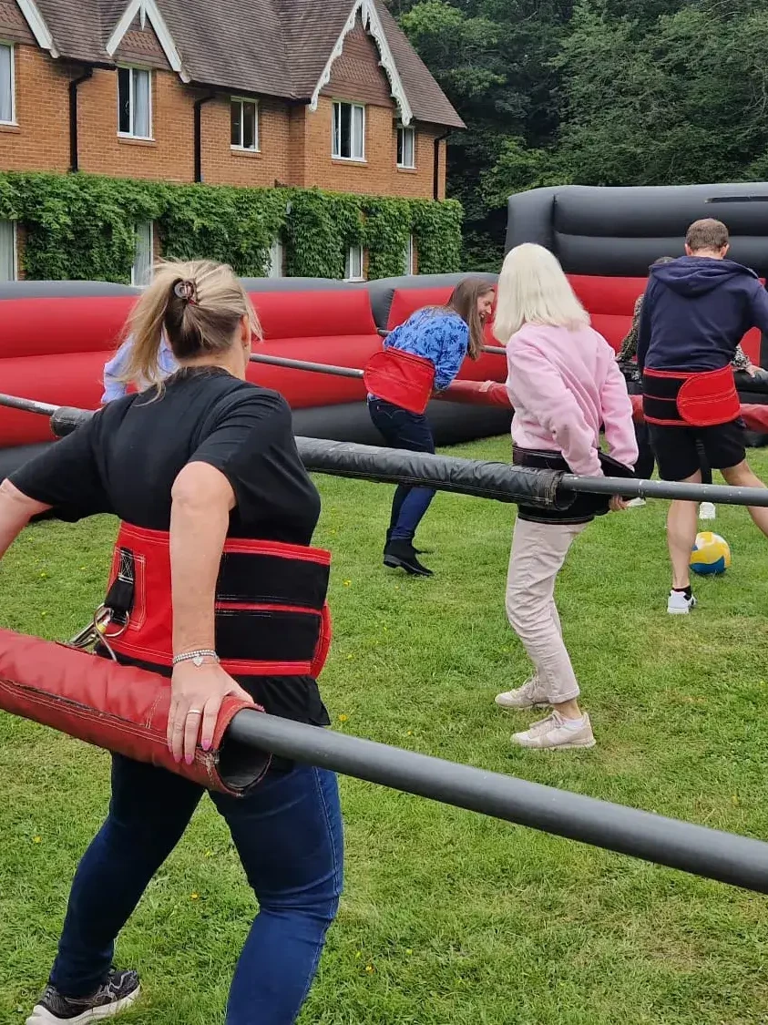 people playing football in Olympic sports day human table football