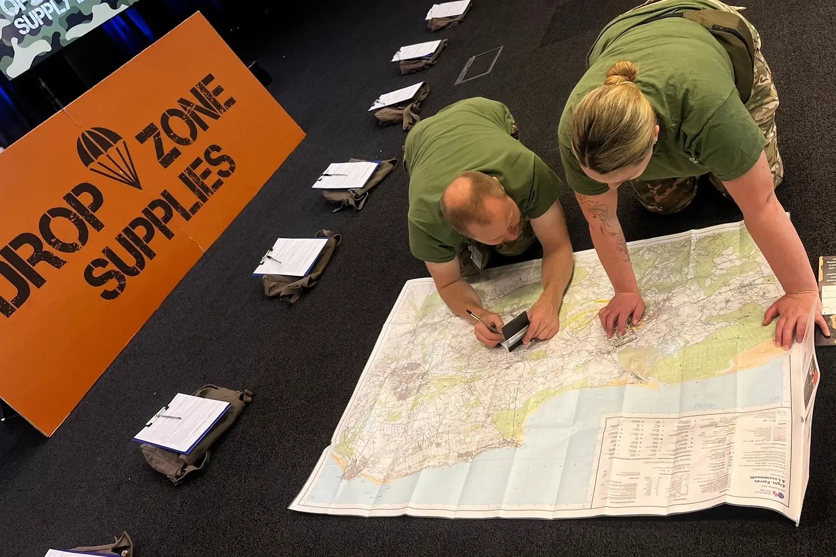 Operation supply drop team building participants reading the map