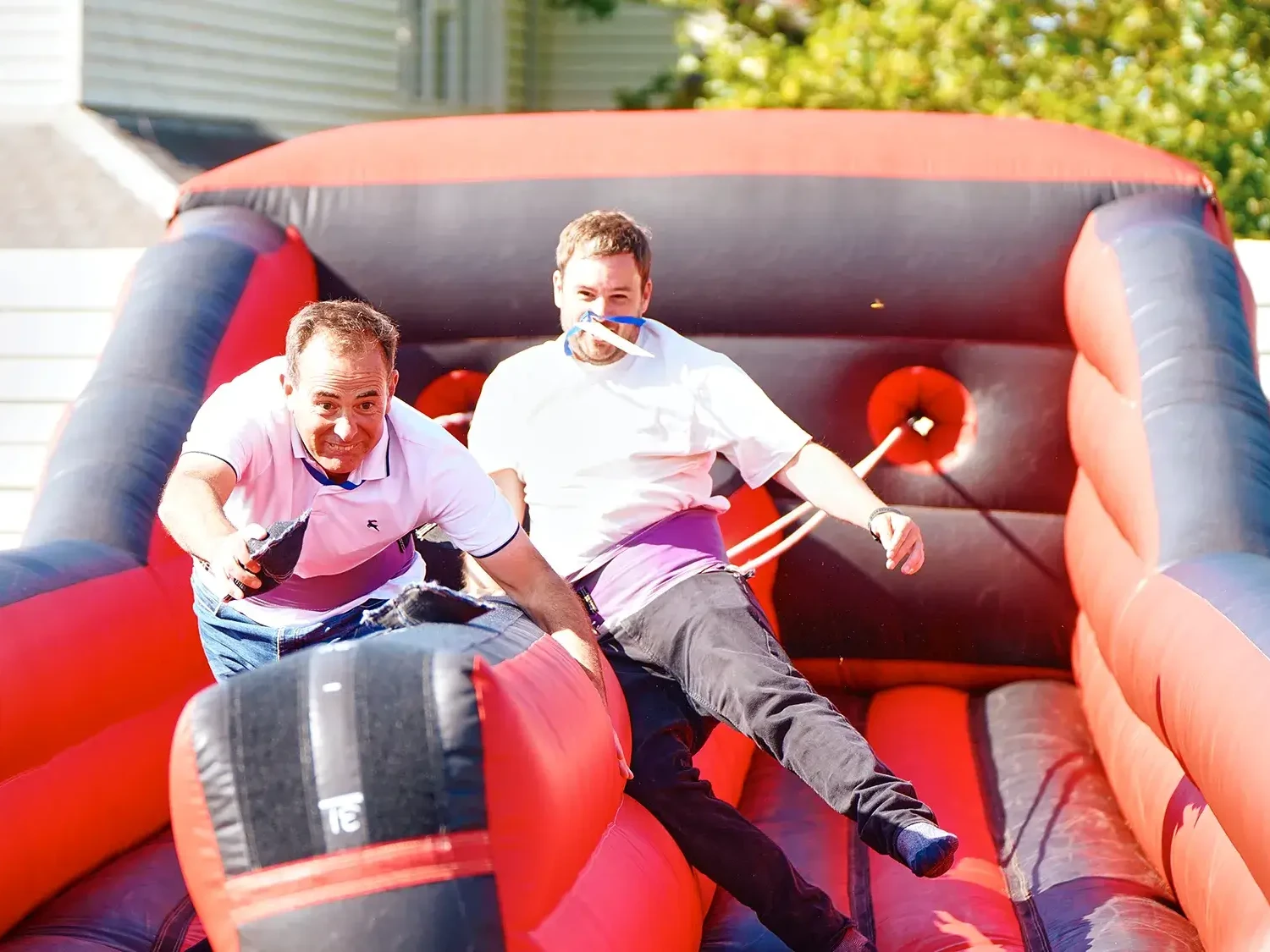 Team building participants competing on inflatable course