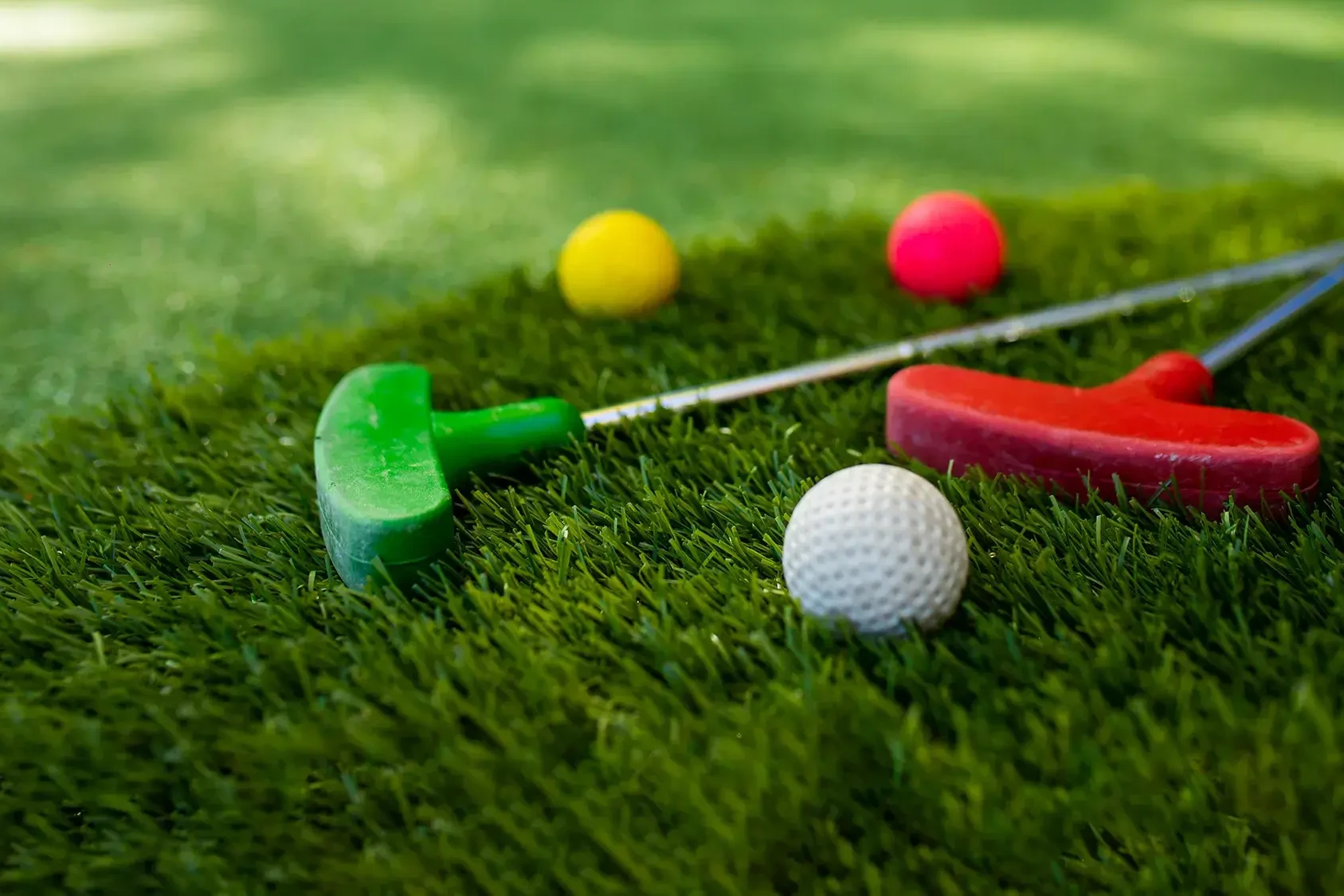 Colourful mini golf putter and golf balls for charity team building event