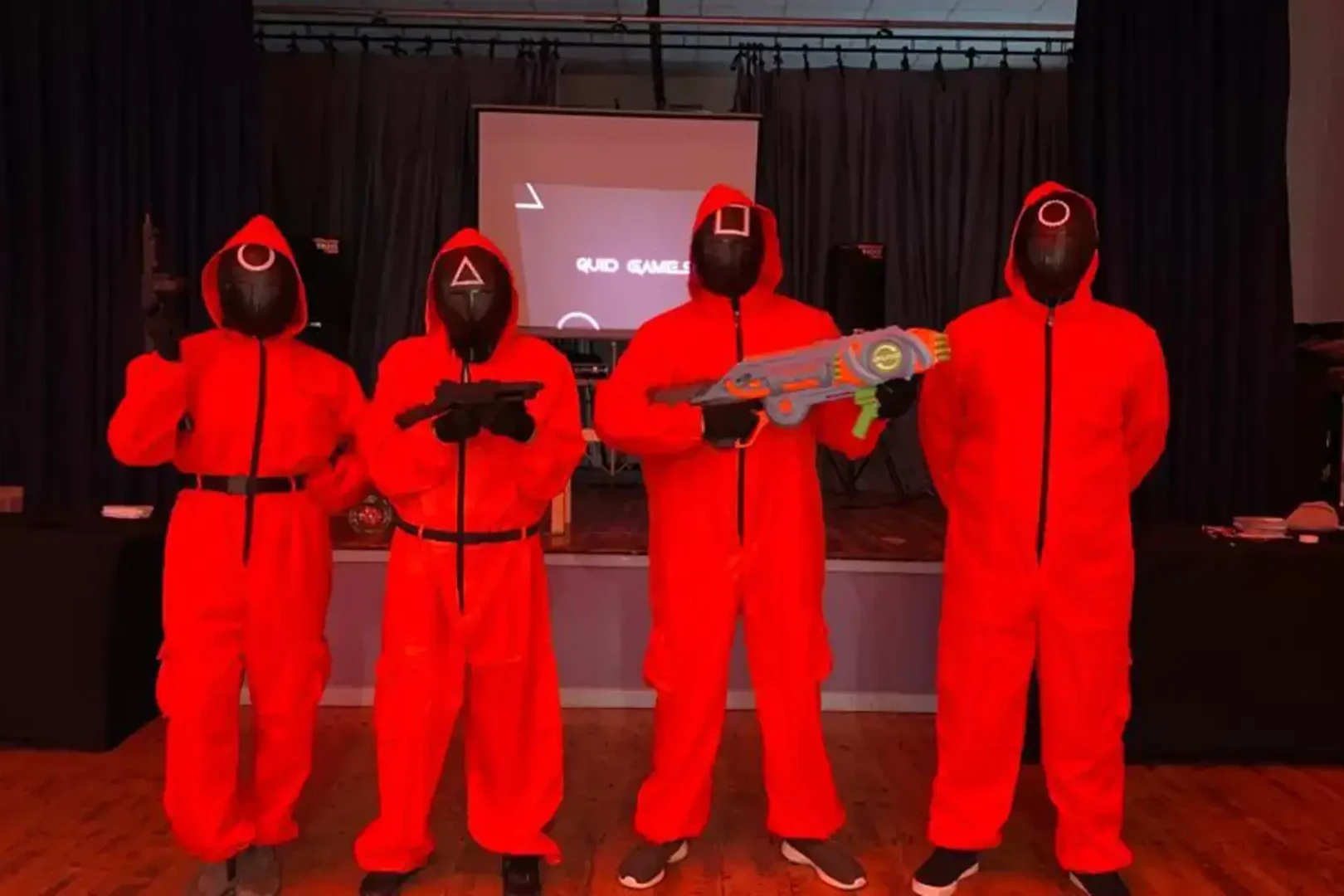 4 guards dressed in red costumes for Quid Games team building event