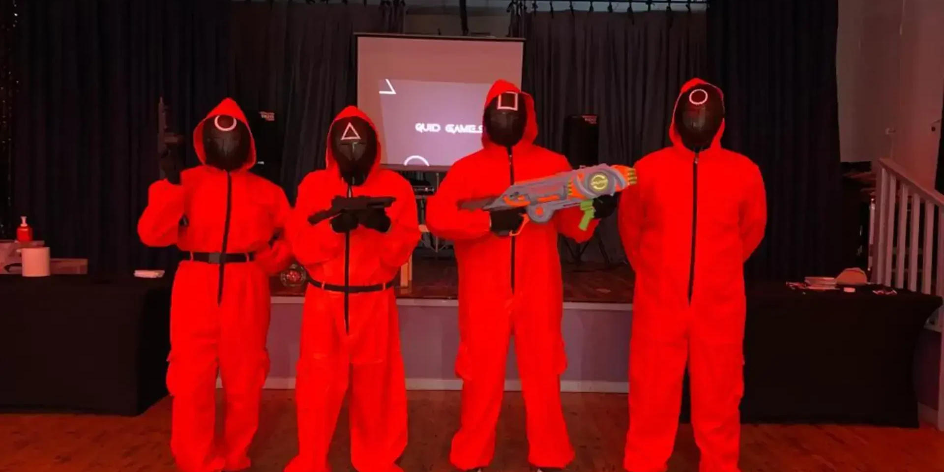 4 guards dressed in red costumes for Quid Games team building event