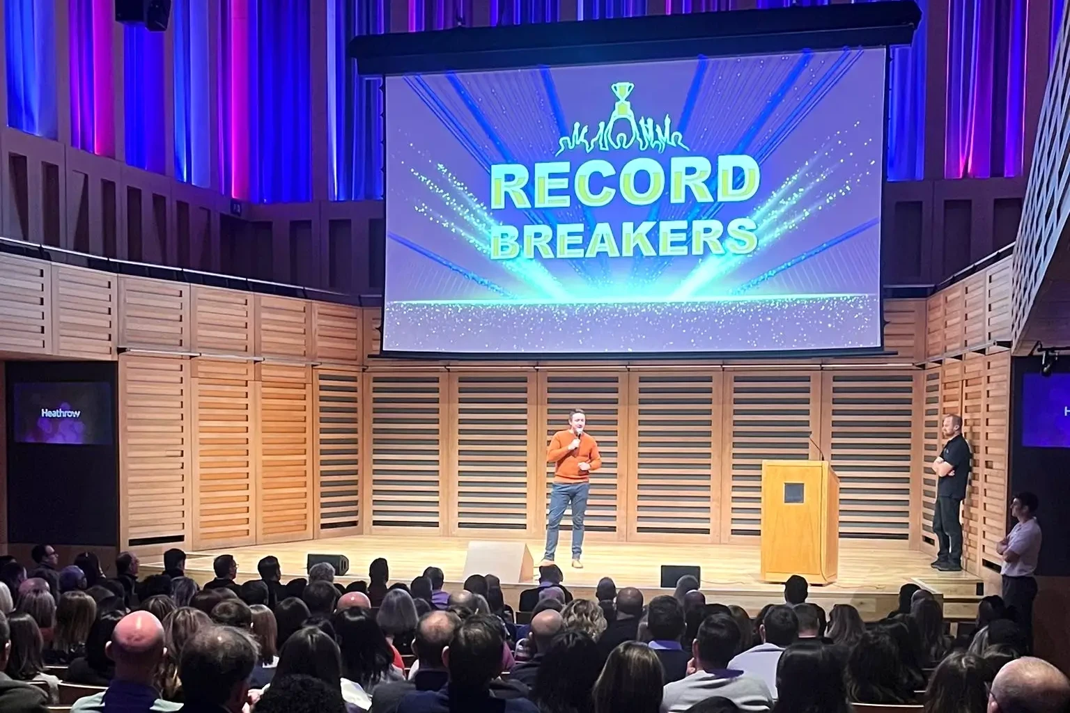 Team building host on stage at Record Breakers event