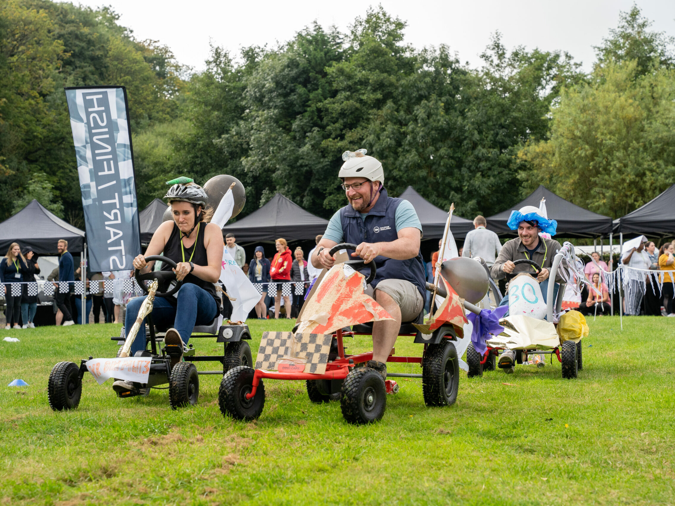 funny race on colourful carts during outdoor team building event