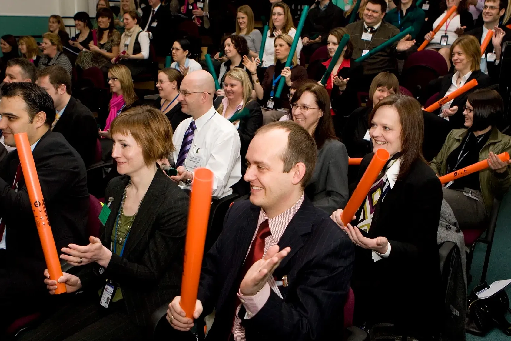 Team building participants holding Boomwhackers in hands