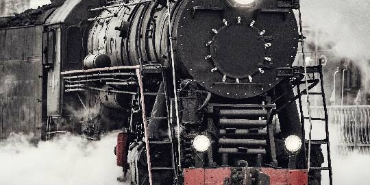 Steam train on railroad tracks