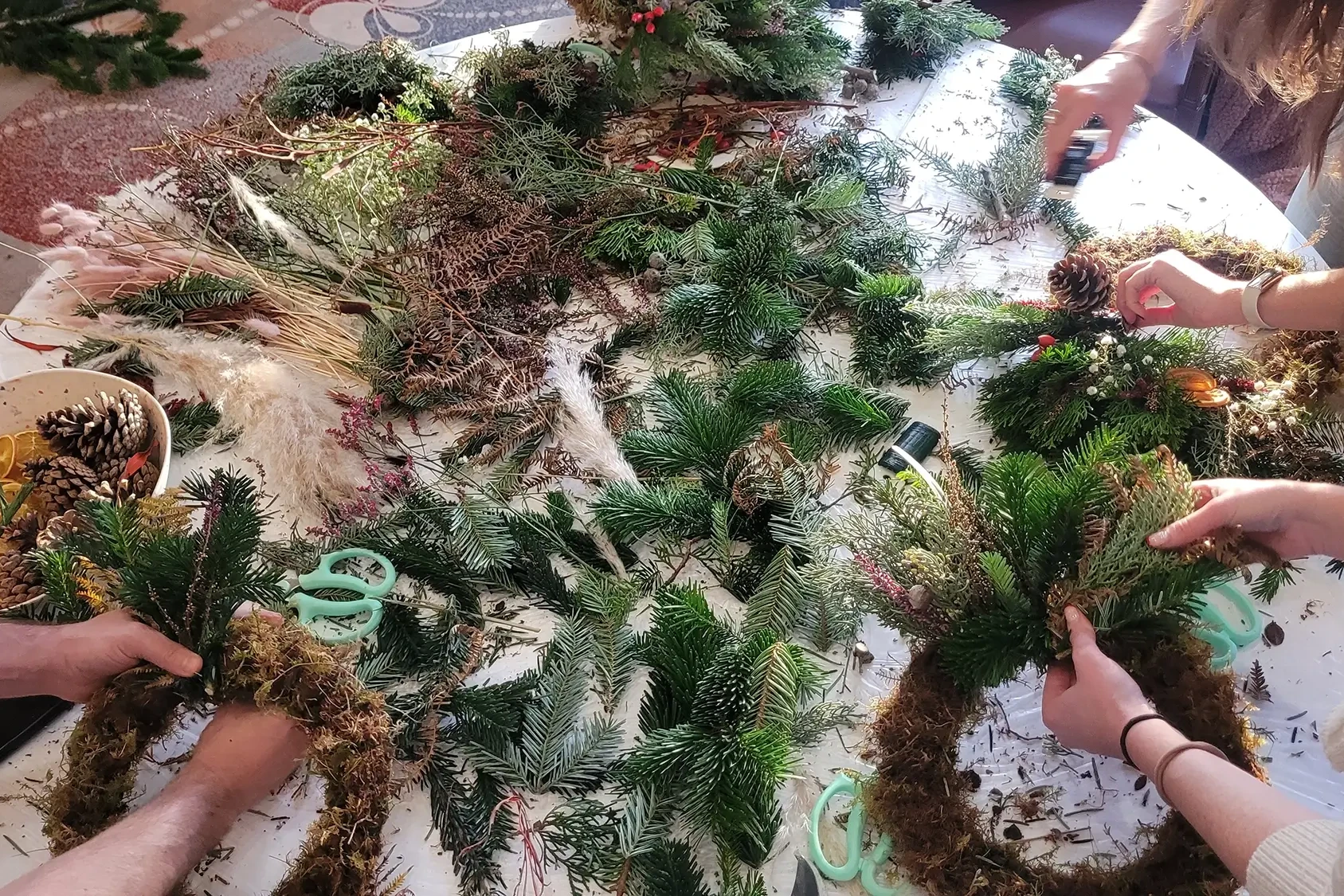 Wreath making workshops with participants choosing materials on the table