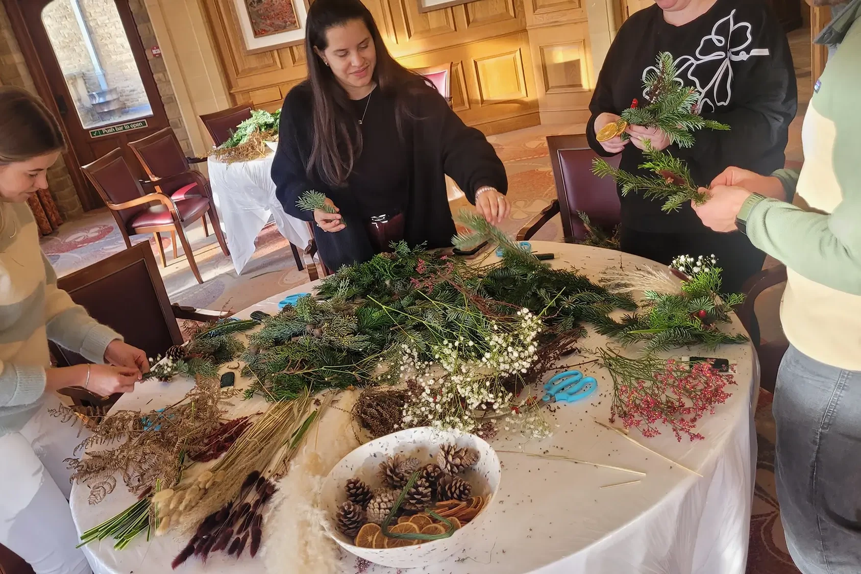 Wreath Making participants crafting with raw materials