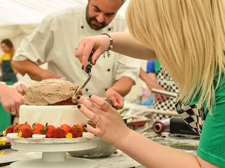 Decorating cake at baking team building activity