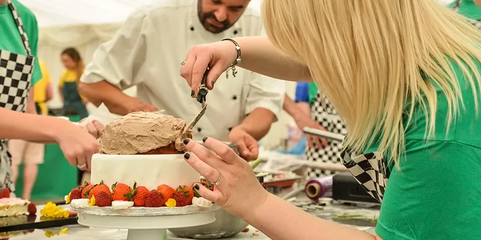 Decorating cake at baking team building activity