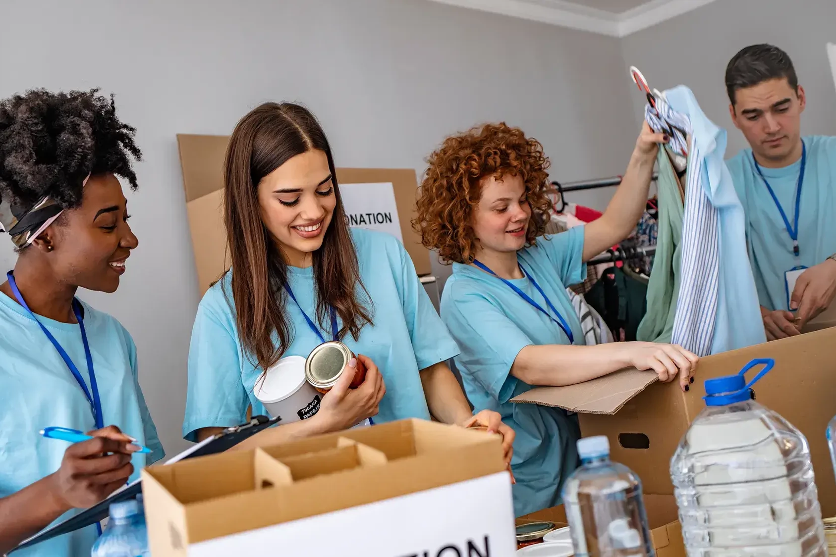 team packing food bank items for donation in charity team building event