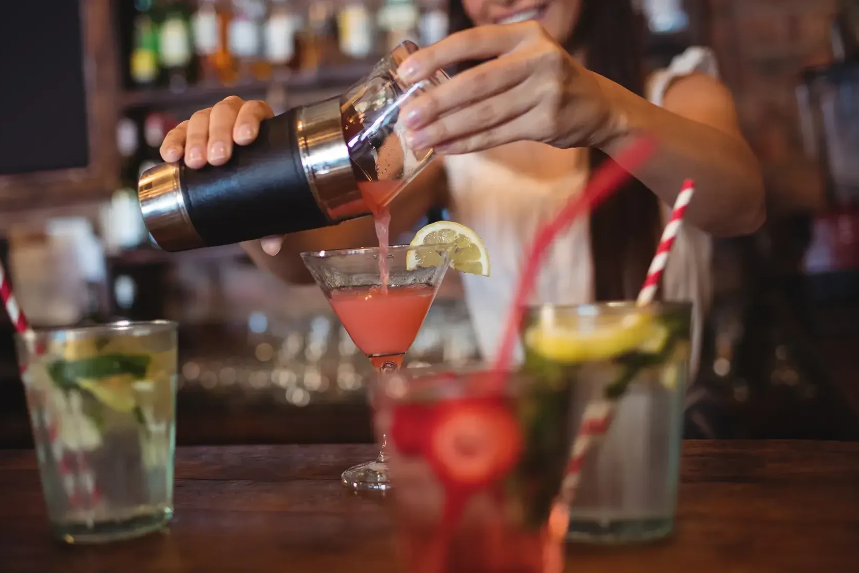 Team building participant mixing cocktails in team challenge