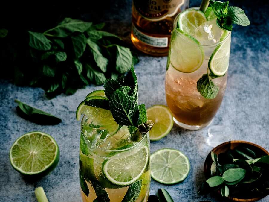 Two cocktails alongside a bottle of Havana Club