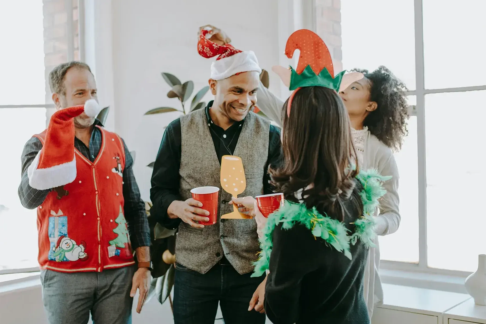 Employees with Christmas outfits celebrating in Christmas team building activity