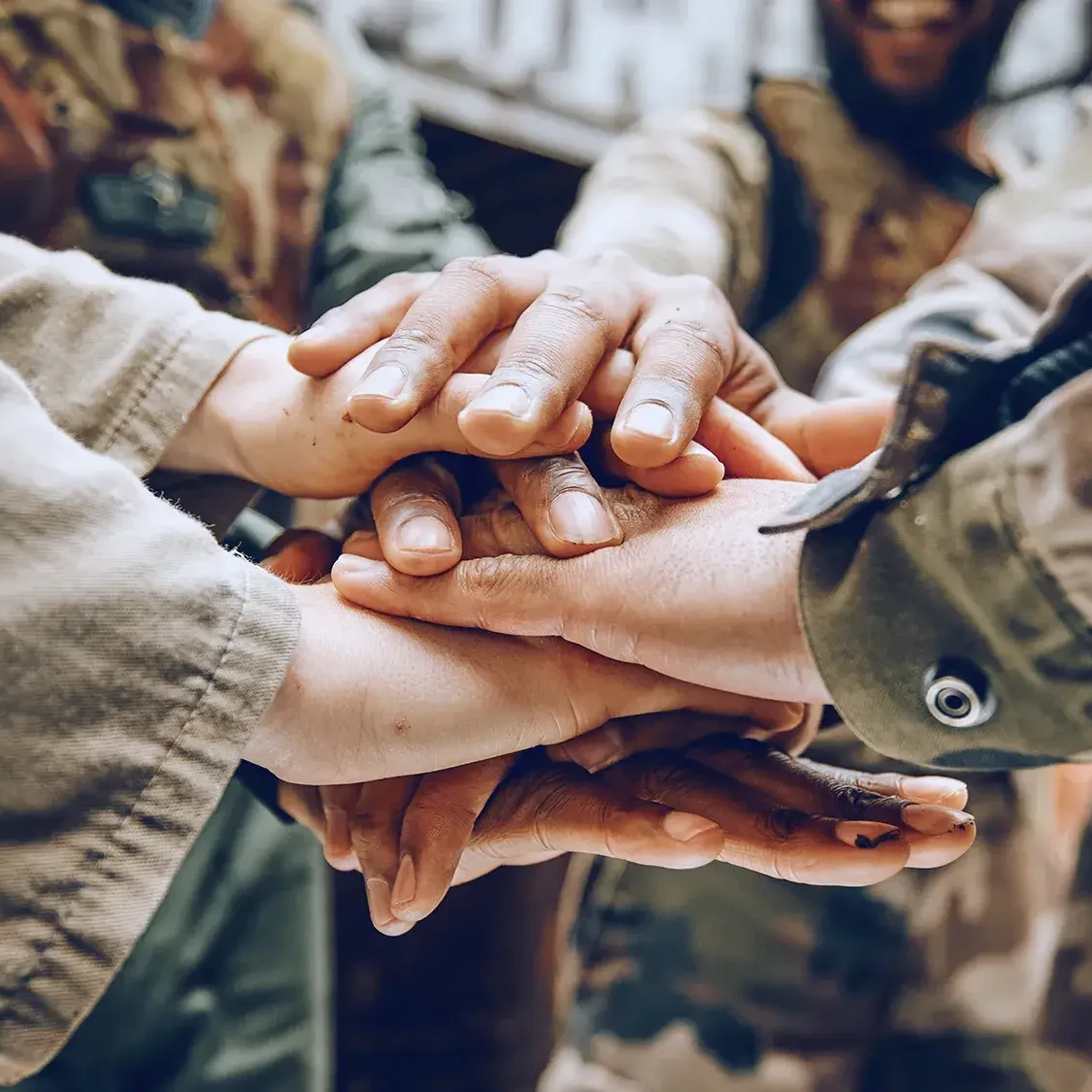 People in army uniforms holding hands in team building activity