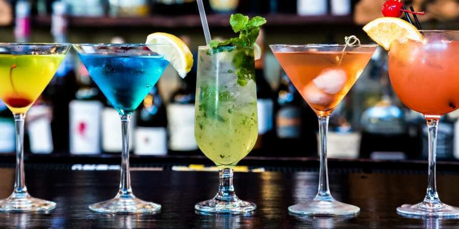 Selection of Cocktails in different shaped glasses on a bar