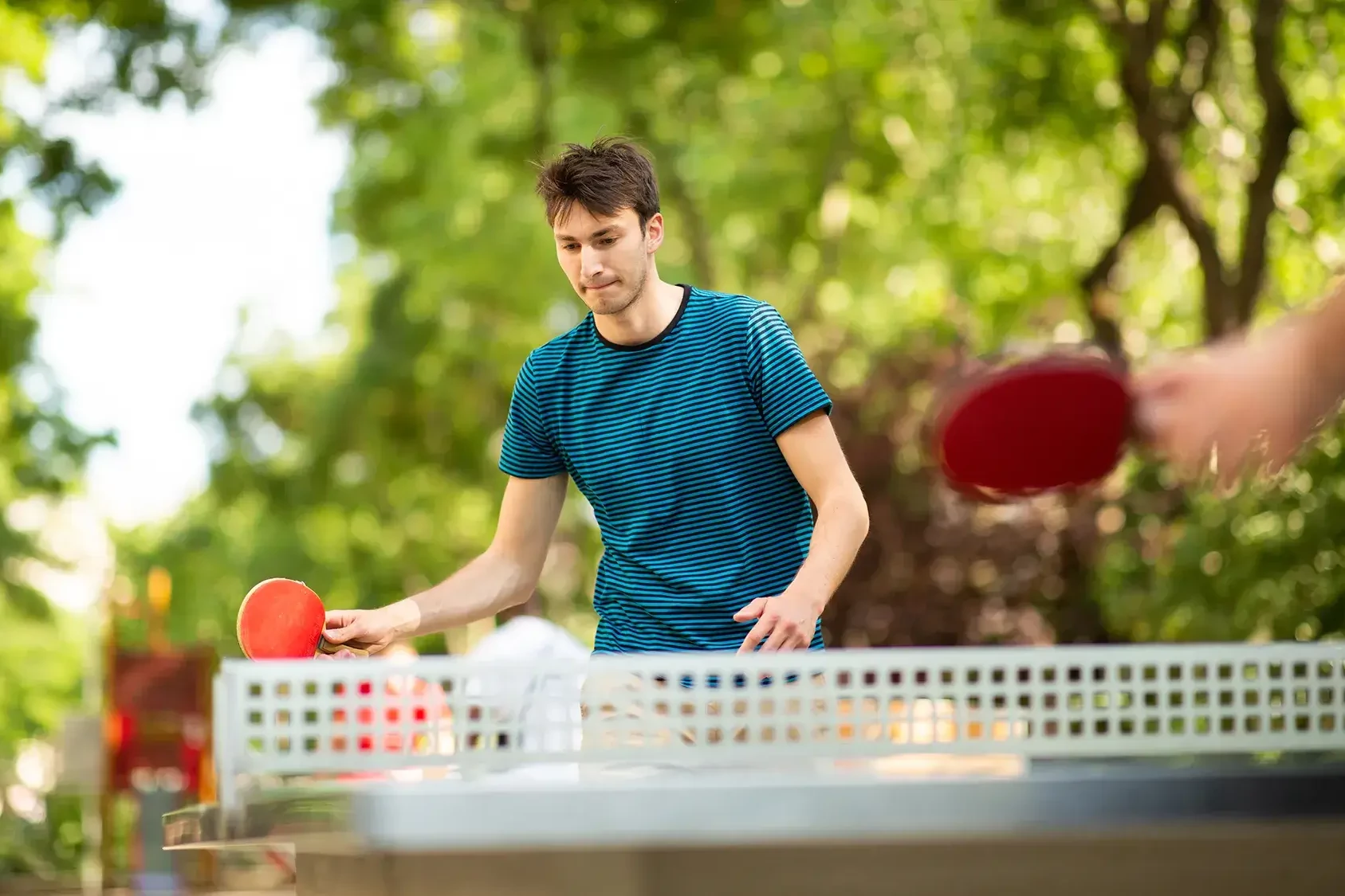 man playing table tennis in outdoor corporate event