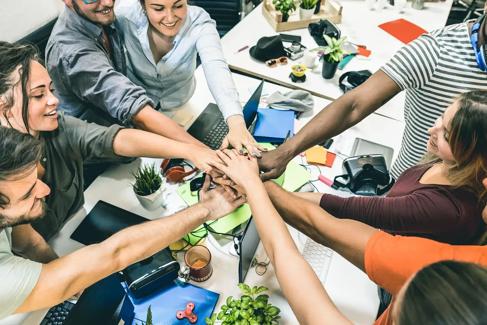 team holding hands in team building activity