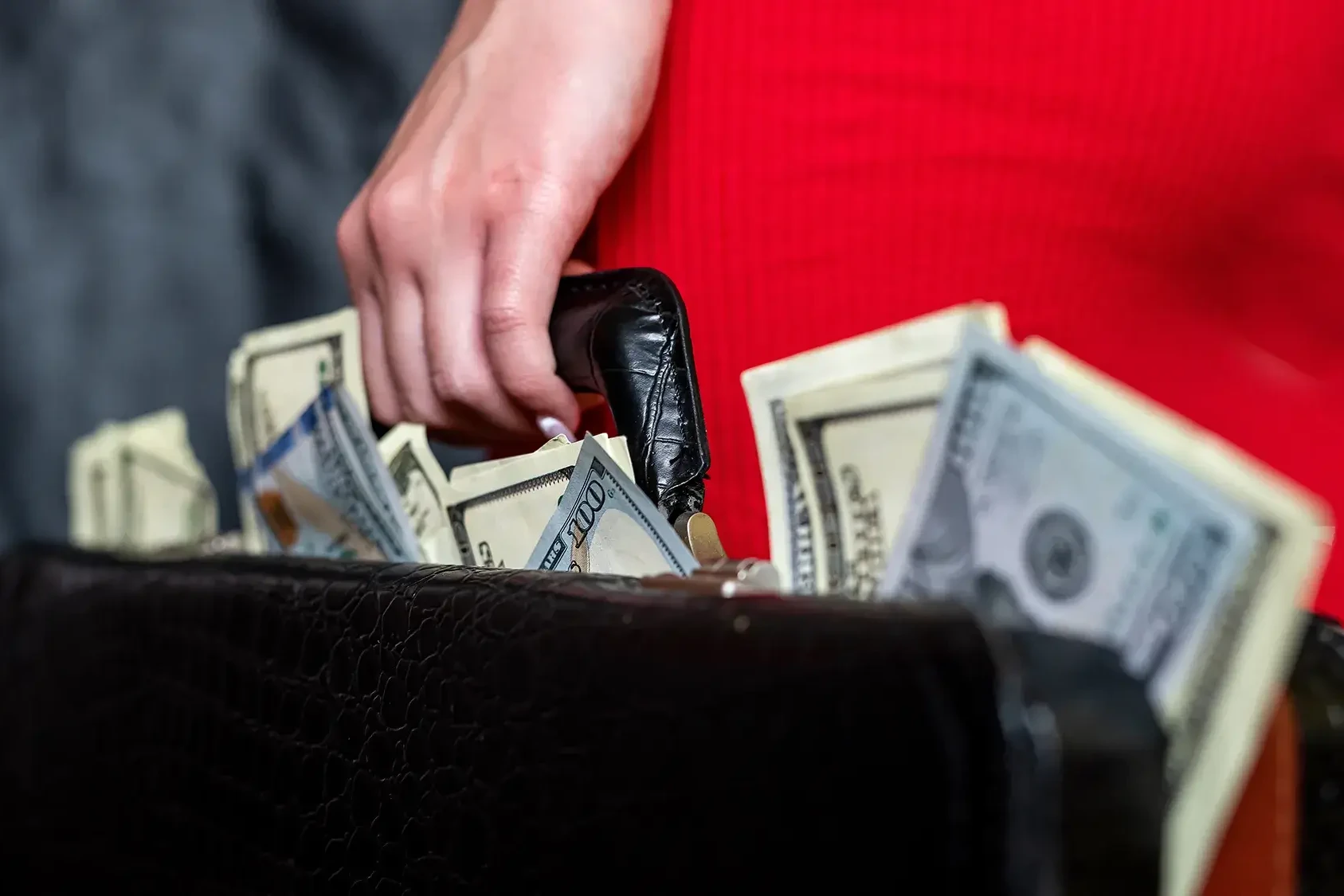 woman with a suitcase full of money