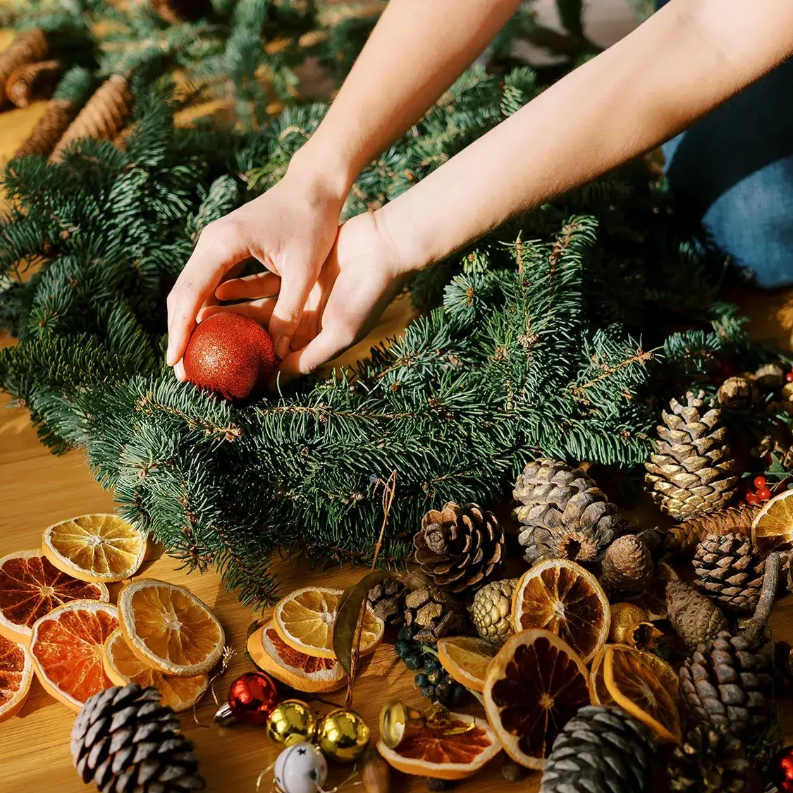 Women decorating a Christmas wreath in wreath making team building activity