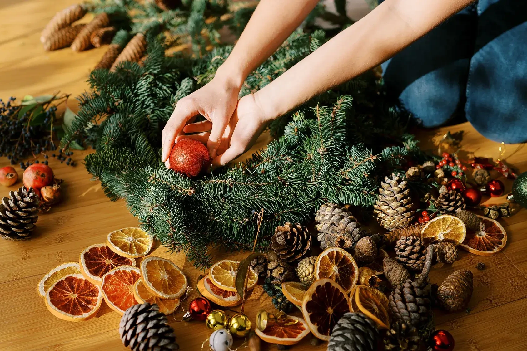 Women decorating a Christmas wreath in wreath making team building activity