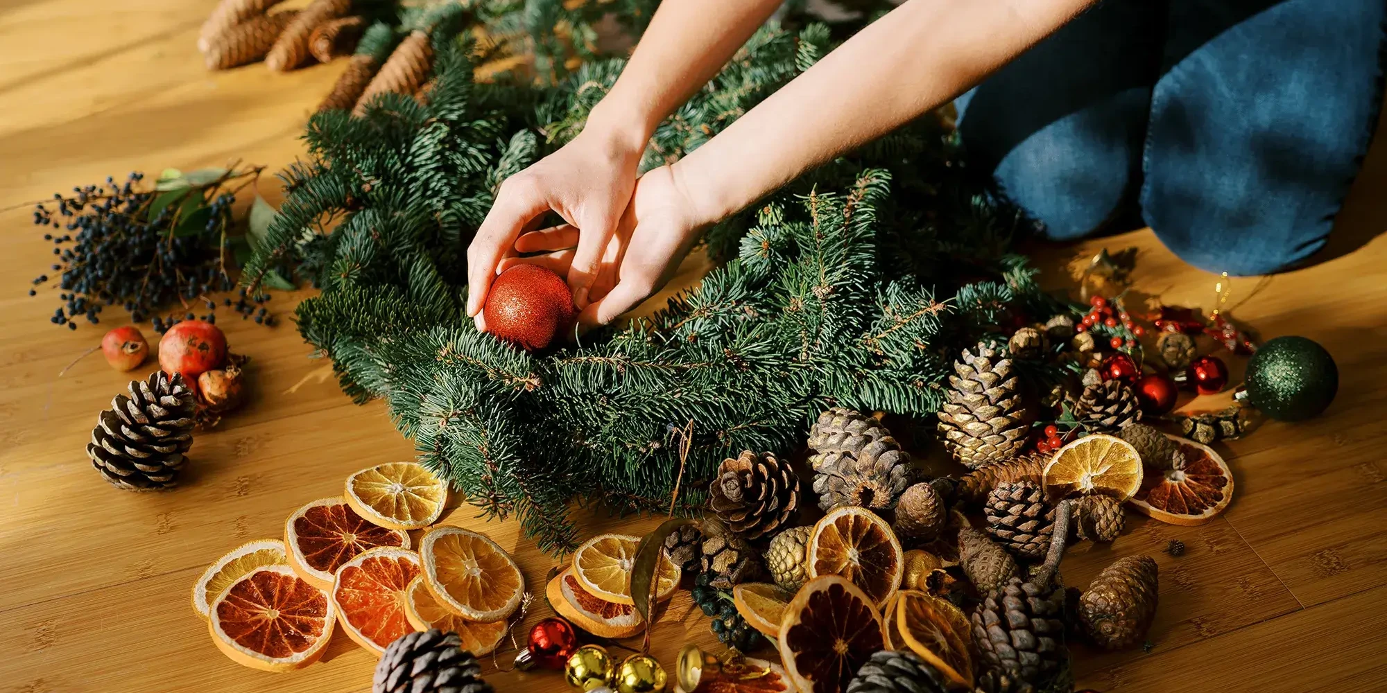 Women decorating a Christmas wreath in wreath making team building activity